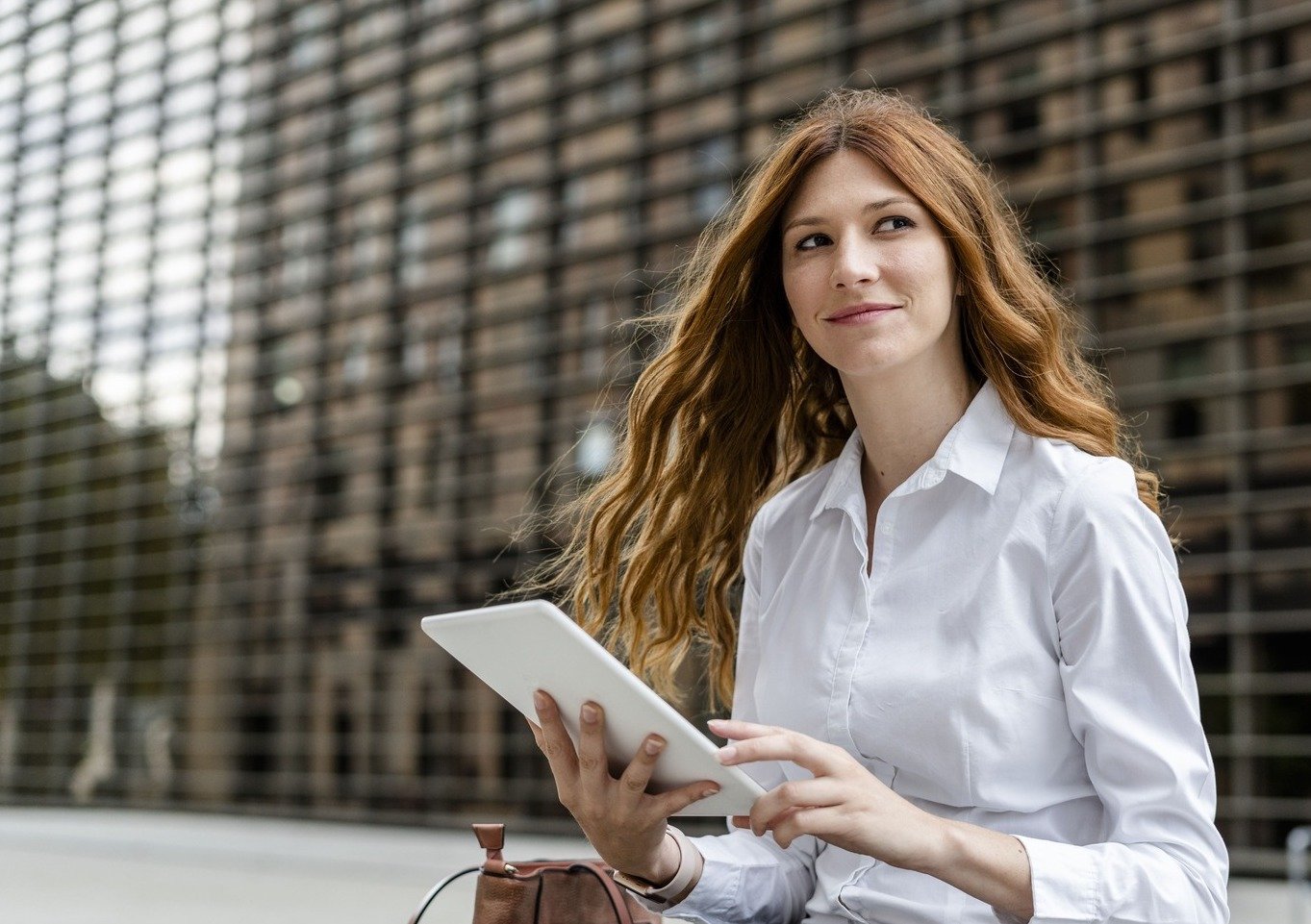 young-businesswoman-in-the-city-using-digital-tab-2022-03-08-01-23-11-utc (3)-1